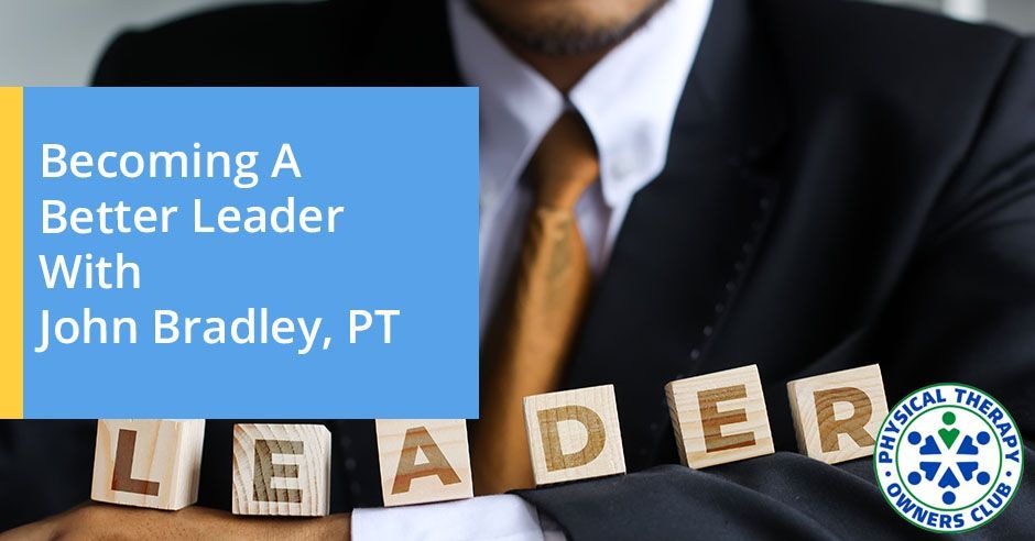 A man in a suit and tie is holding wooden blocks that spell out the word leader