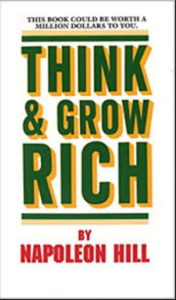 A book titled think and grow rich by napoleon hill