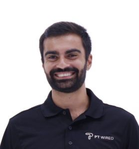 A man with a beard wearing a black pt wired polo shirt