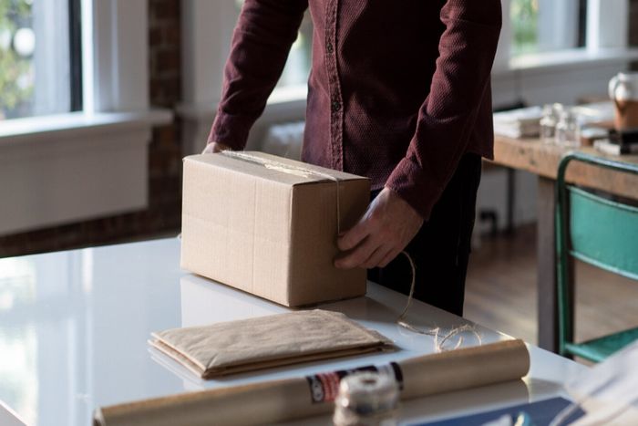 Pharmacy staff member organizing medical supplies for free same-day prescription delivery.