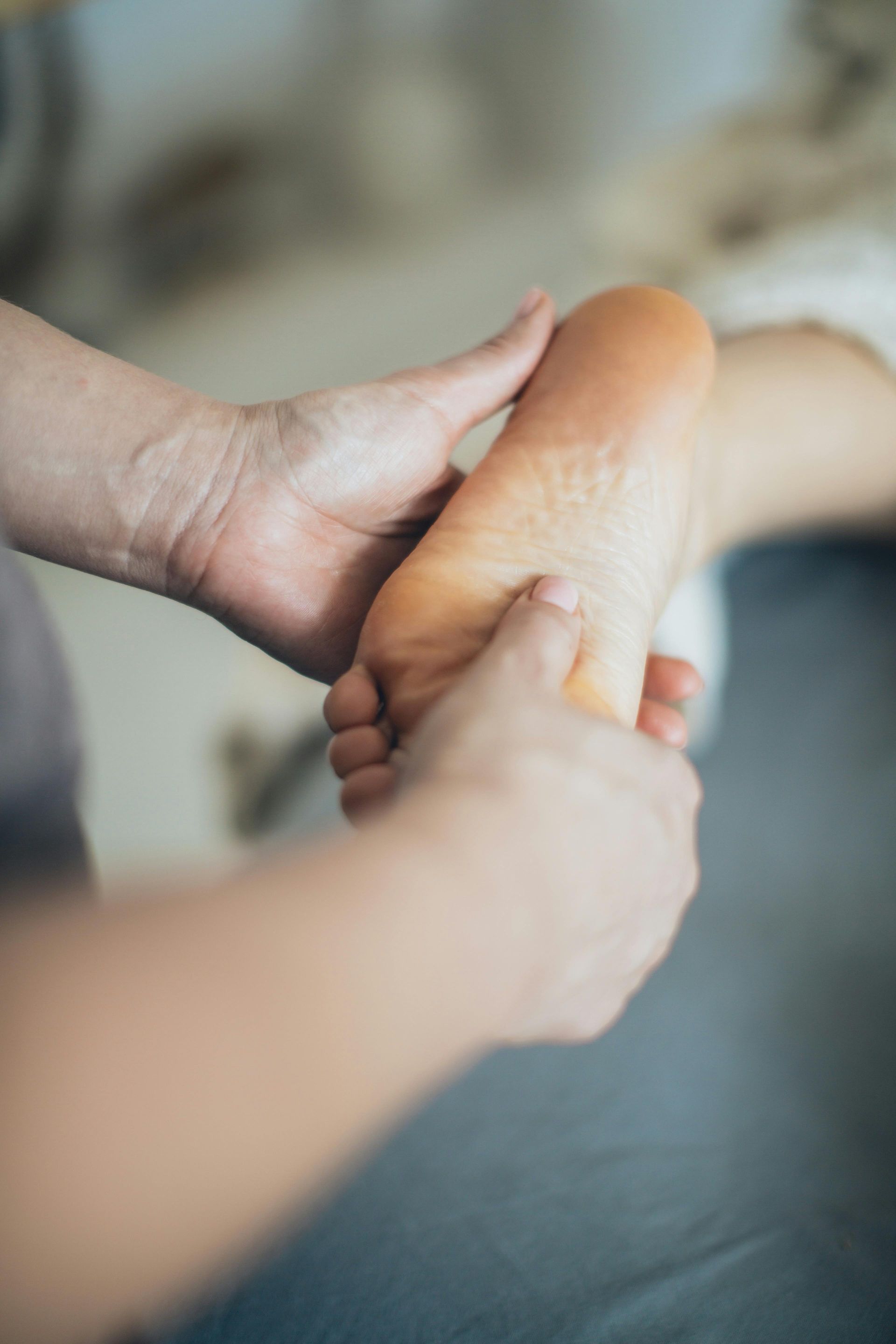 A person is giving a foot massage to another person.