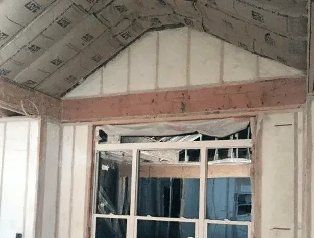 A house is being built with a lot of insulation and a window.