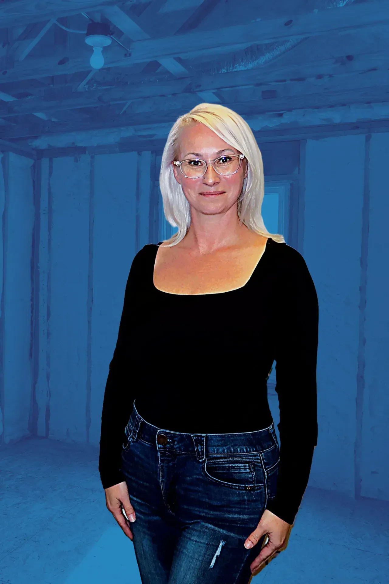 A woman in a black shirt and jeans is standing in a room with a blue background.