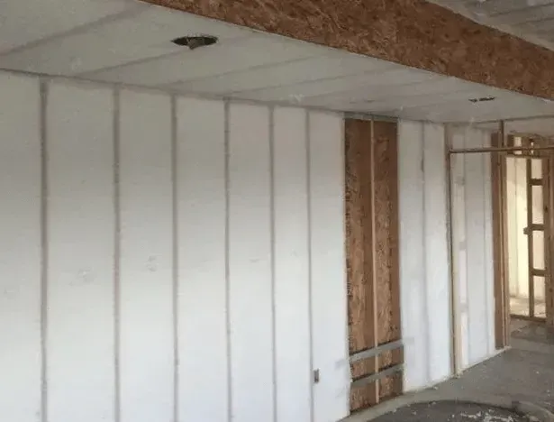 A room with a lot of white walls and a ceiling.