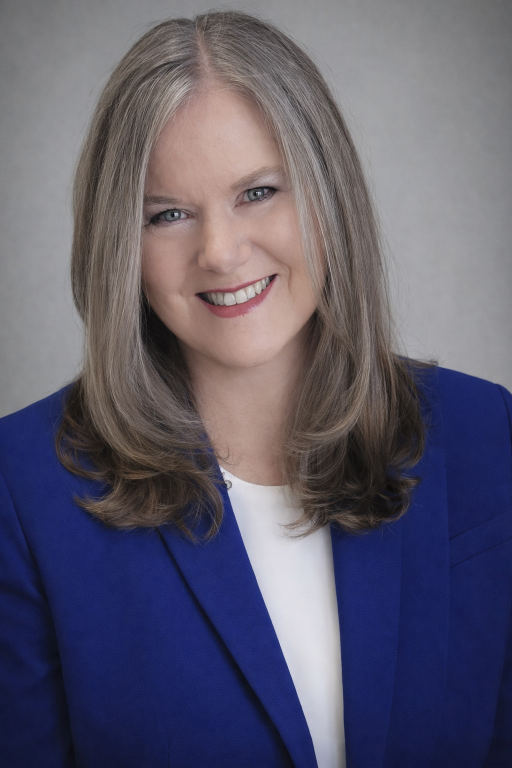 A man in a suit is standing with his hands in his pockets