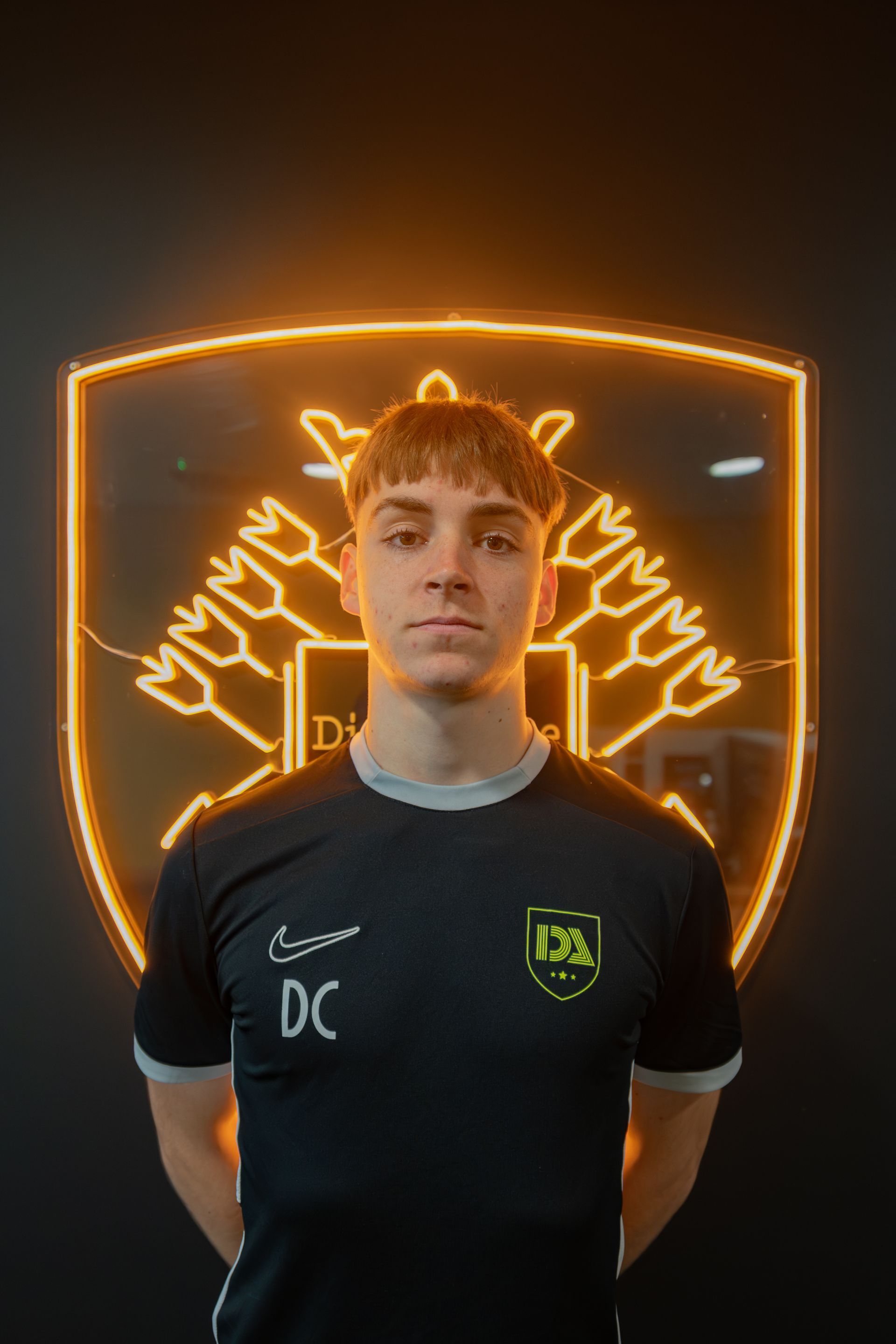 Young man in black shirt with initials 