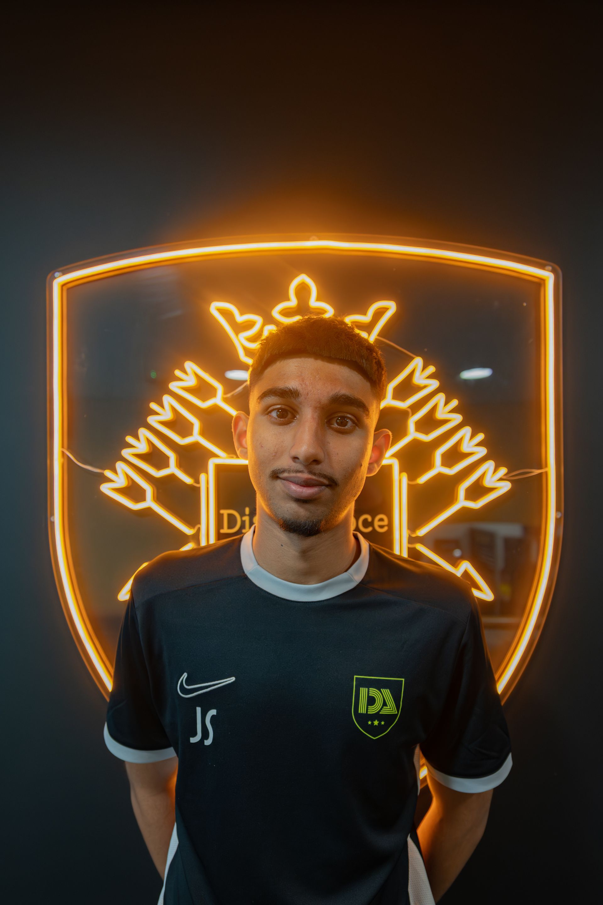 Man in a black shirt with initials 