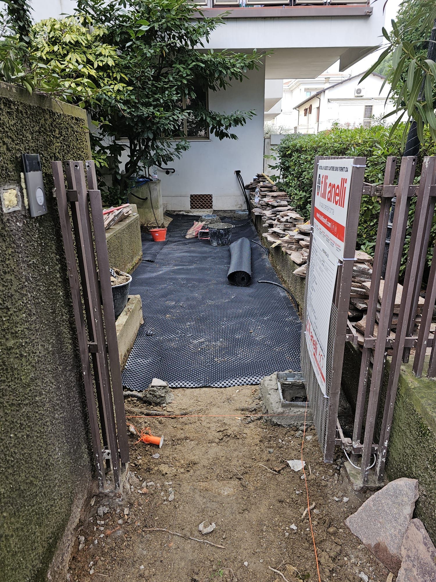 Un sentiero che porta a una casa con un cartello sul lato.