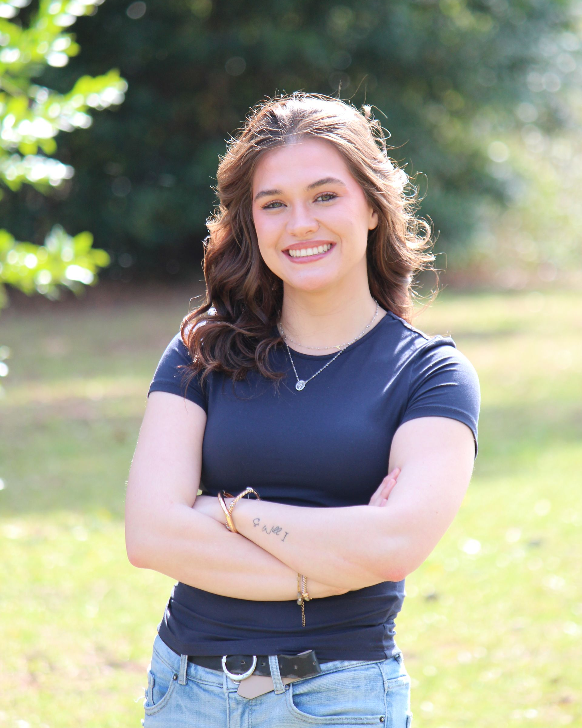 Woman's faceless silhouette; gray scale. Shows a head and shoulders with bobbed hair and scoop neck.