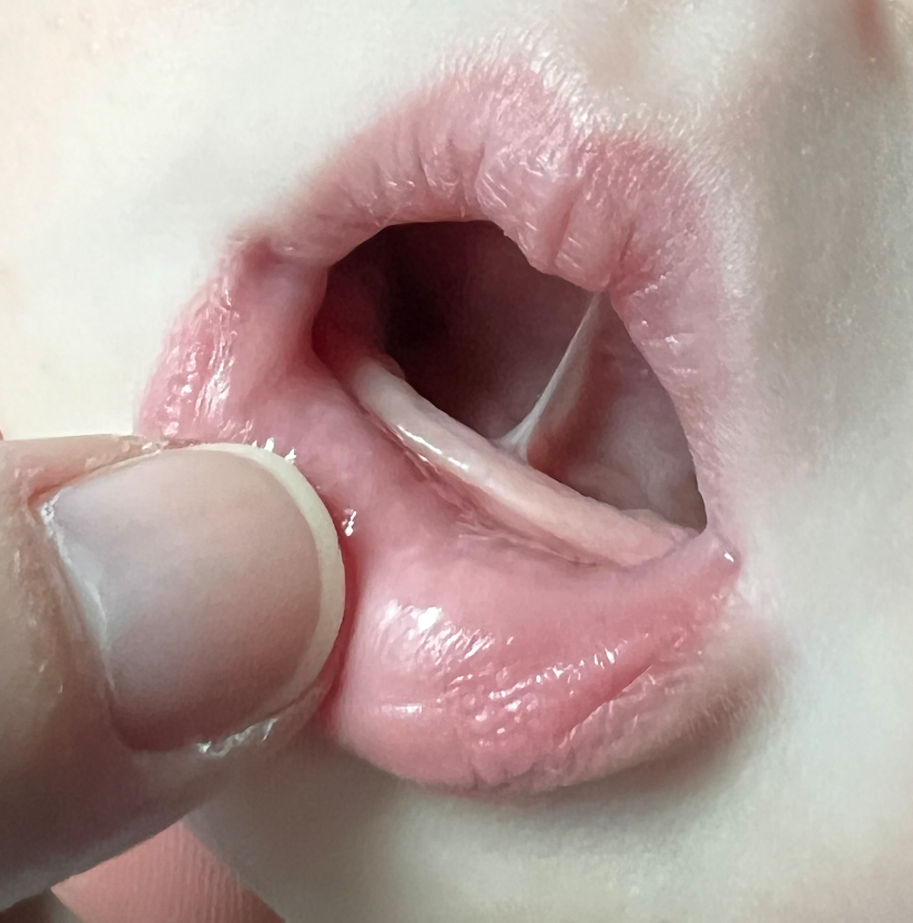 a close up of a person 's mouth with their tongue sticking out