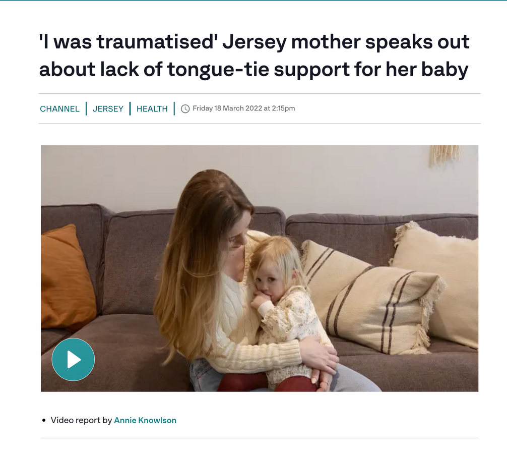 a woman is sitting on a couch holding a baby .