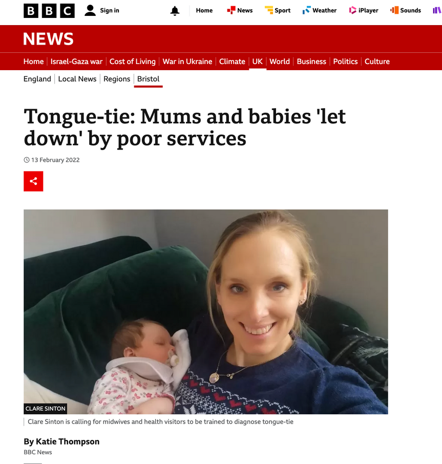 a woman is holding a baby on a bbc news page 