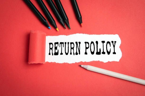 a piece of torn paper with the word return policy written on it 