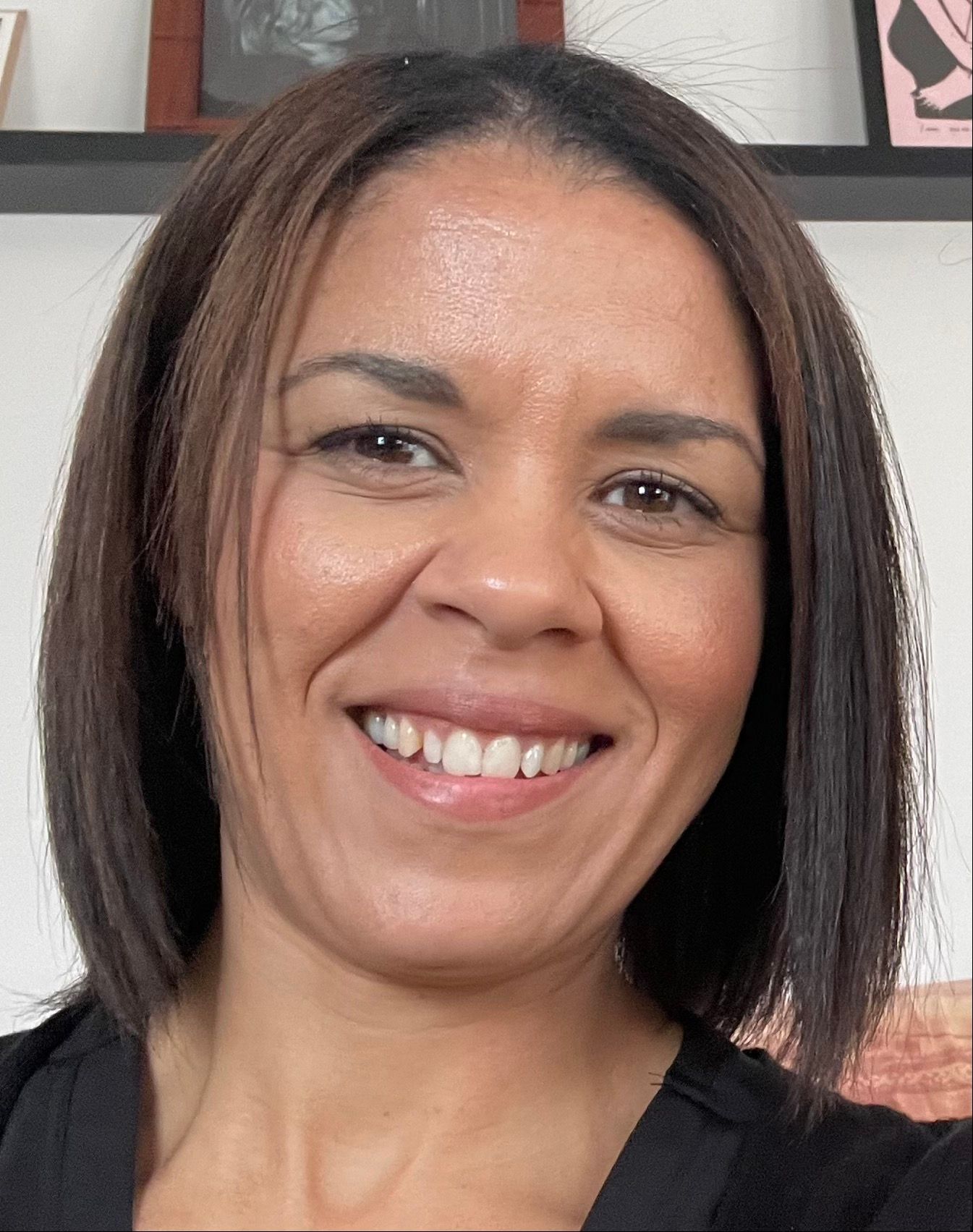 a woman with short brown hair is smiling for the camera 