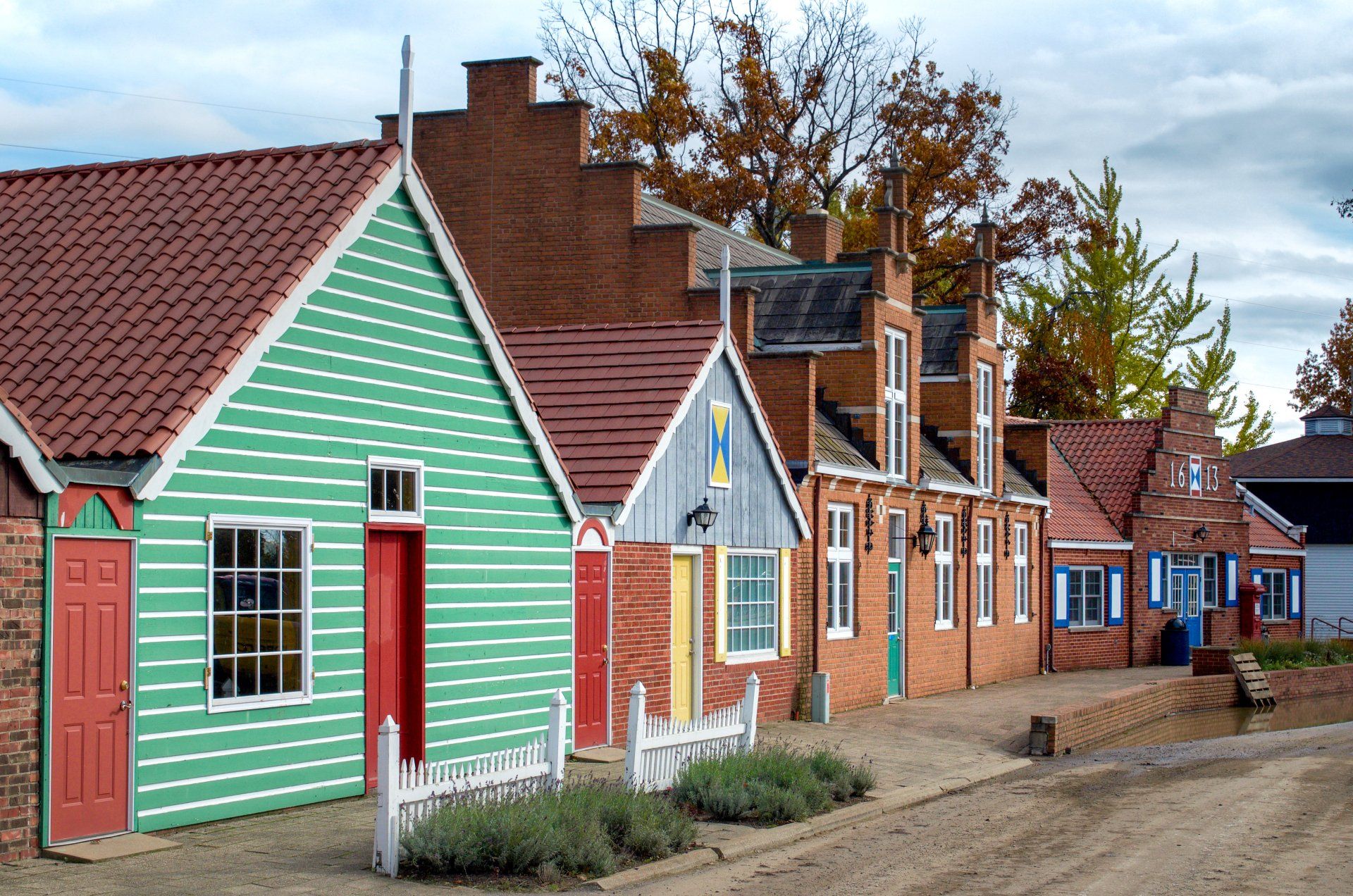 A row of small houses with green and red siding