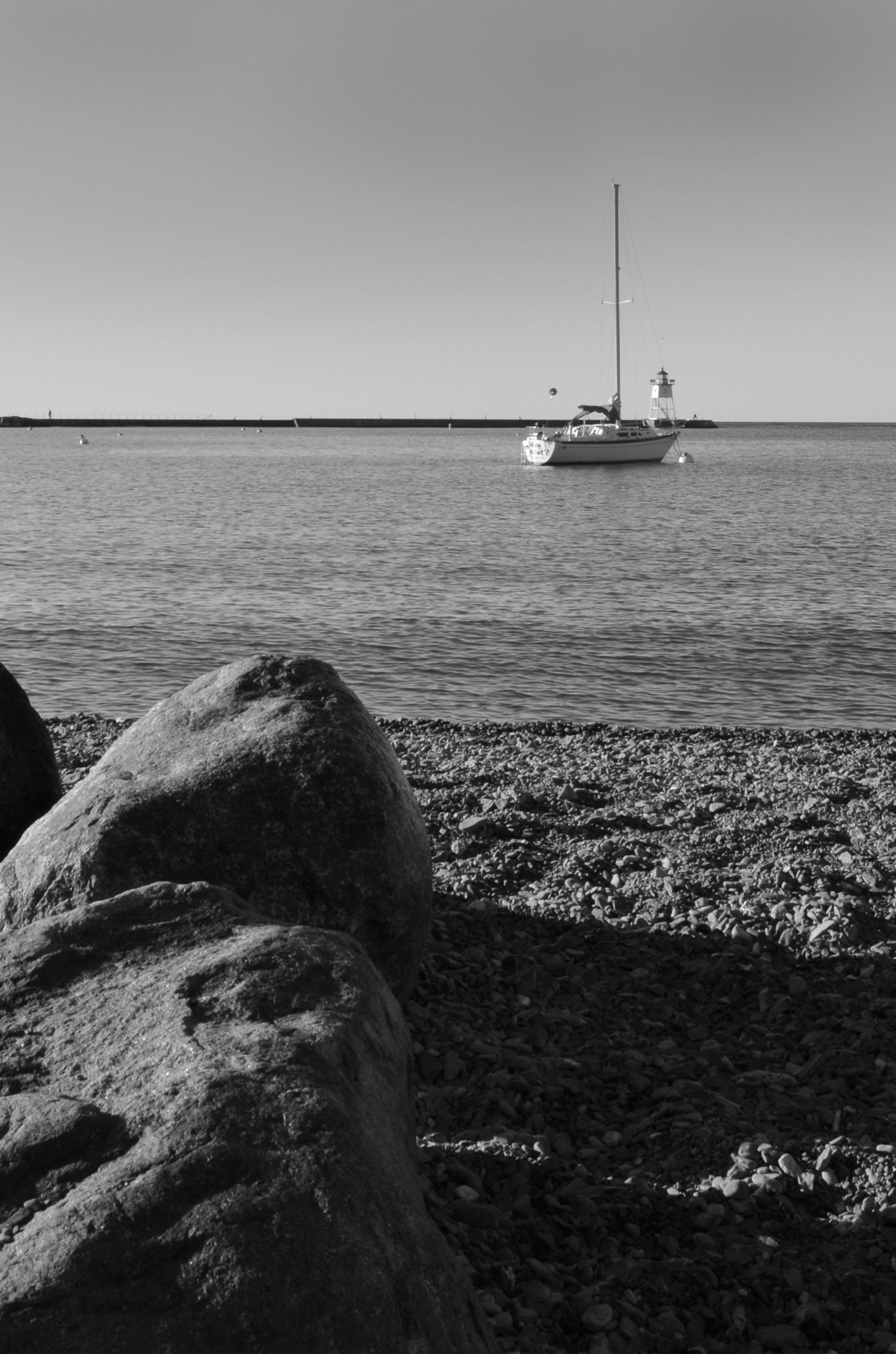 A black and white photo of a boat in the water