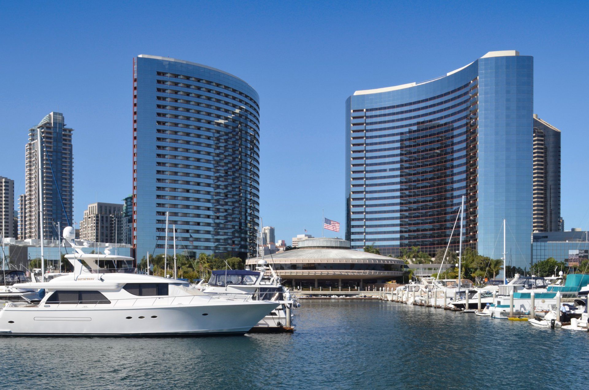 A boat is docked in front of a large building