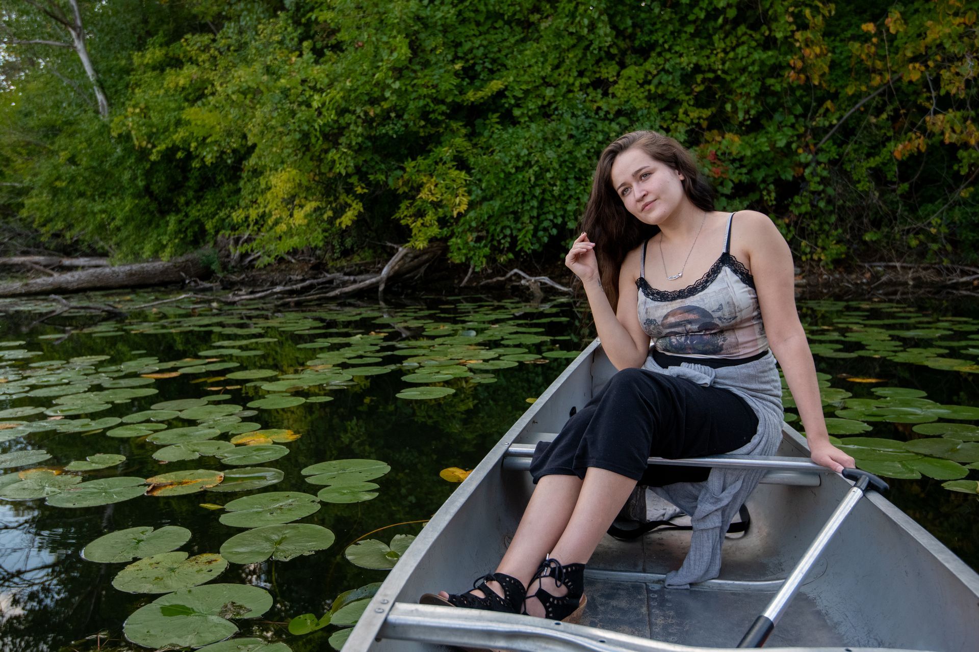 A woman is sitting in a canoe on a lake