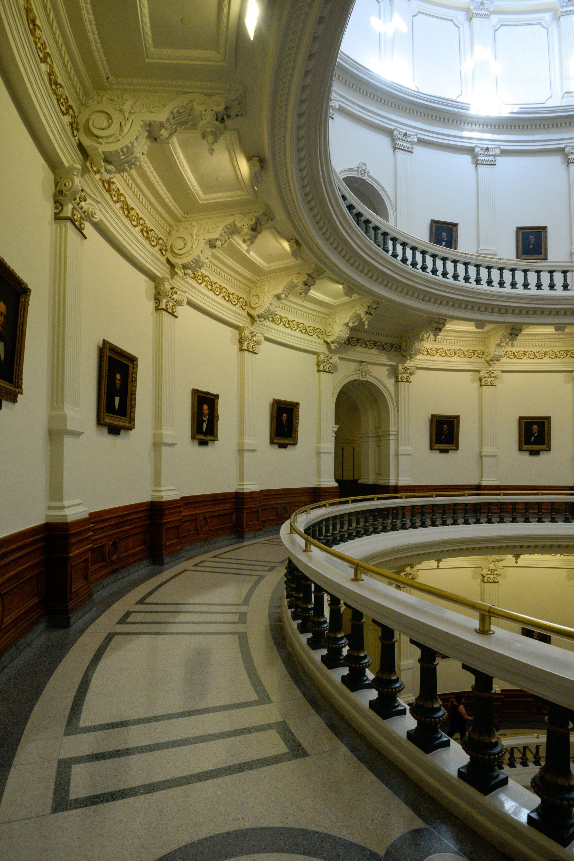 The inside of a building with a dome and stairs