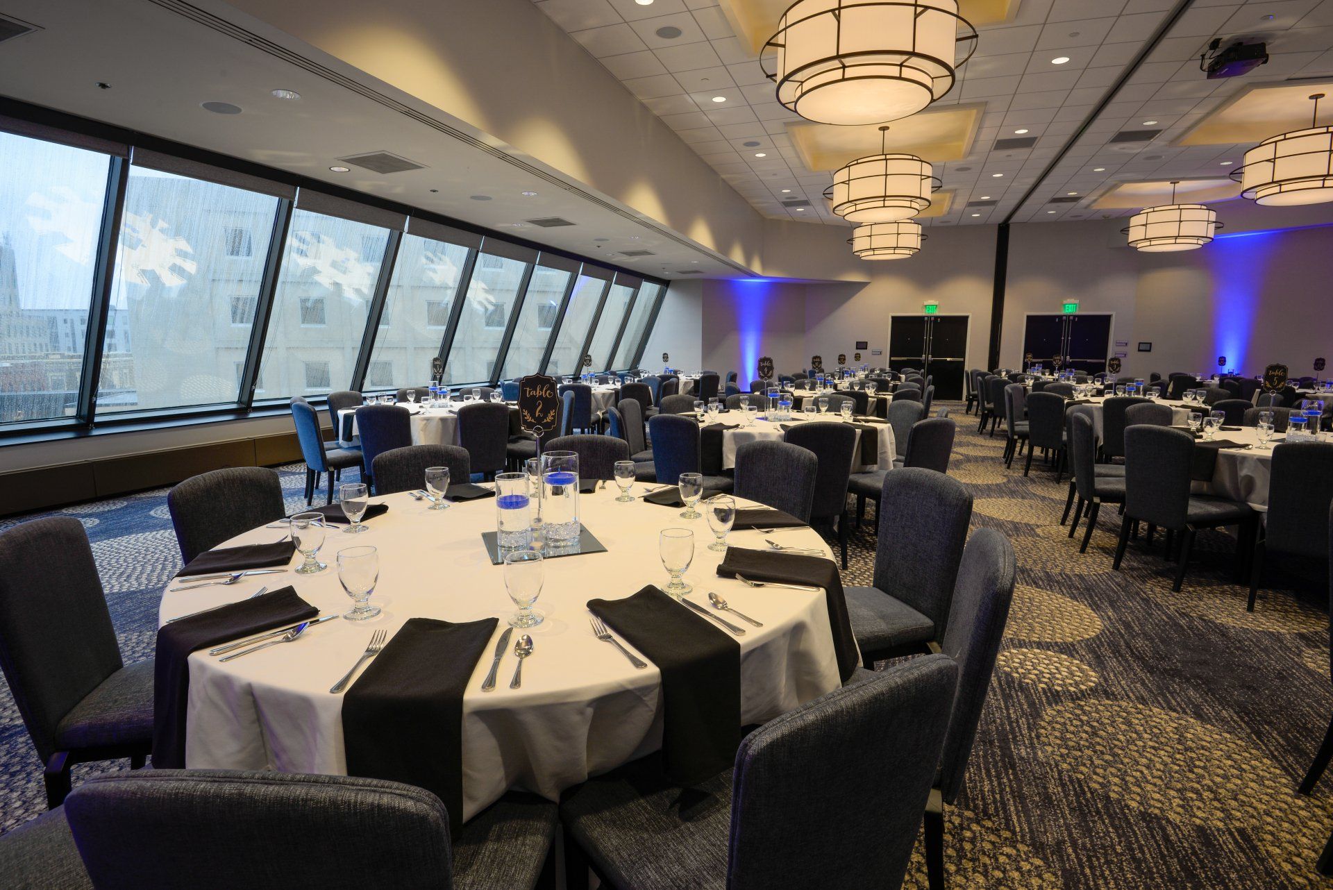 A large room with tables and chairs set up for a banquet