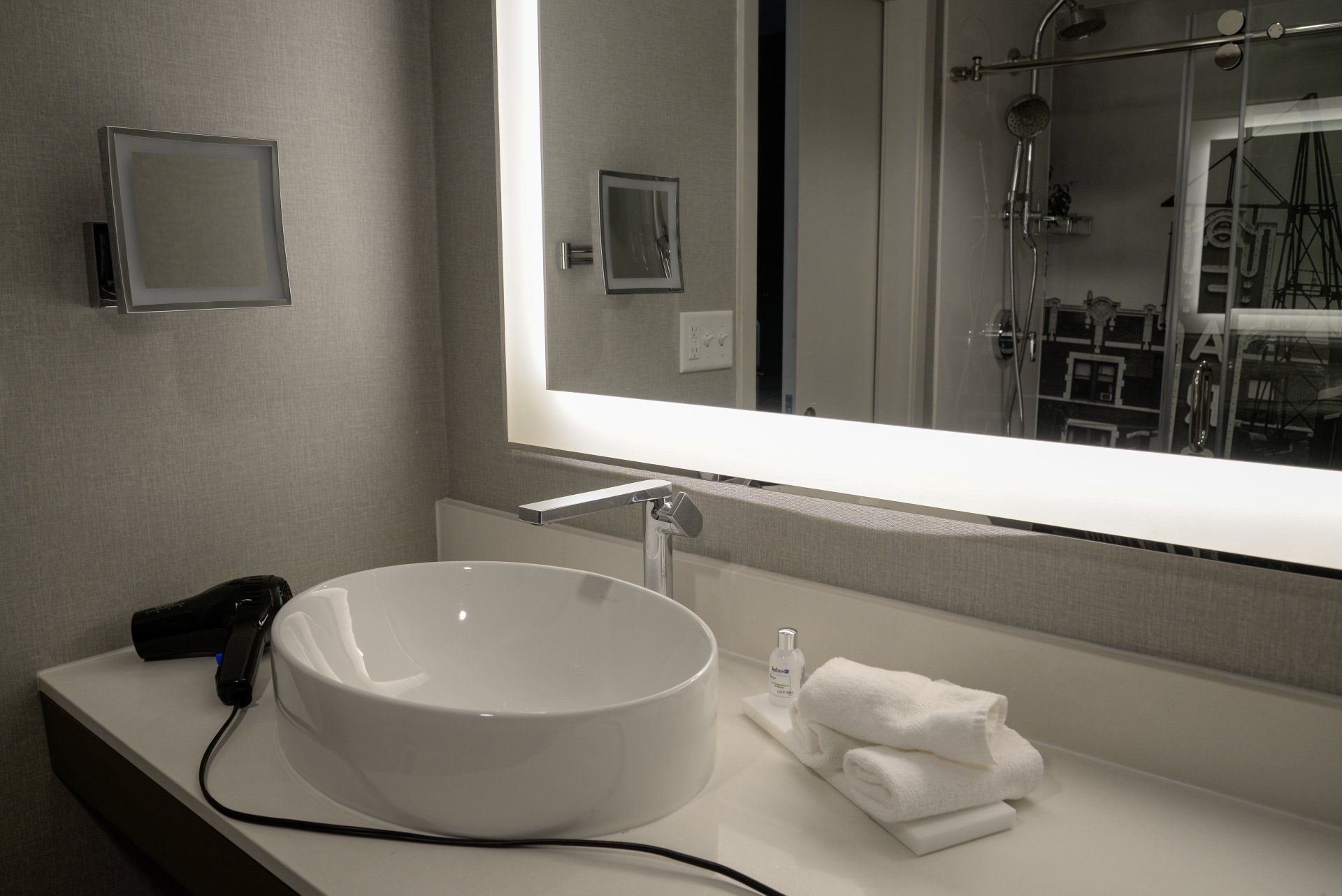 A bathroom with a sink and a large mirror