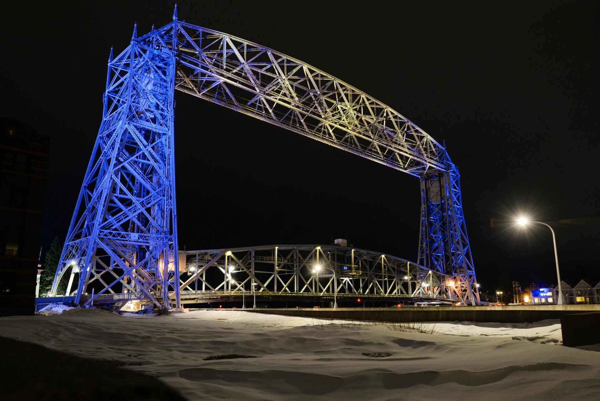A bridge is lit up with blue lights at night