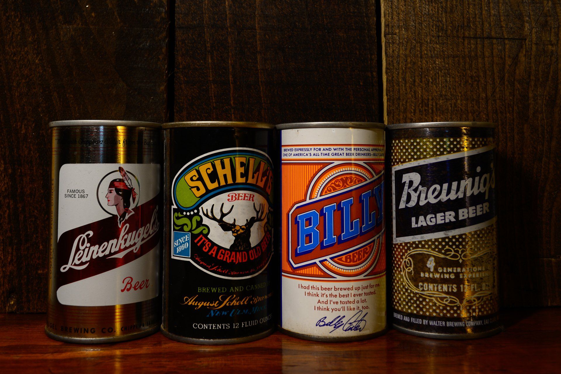 Four cans of beer one of which says brewing on it