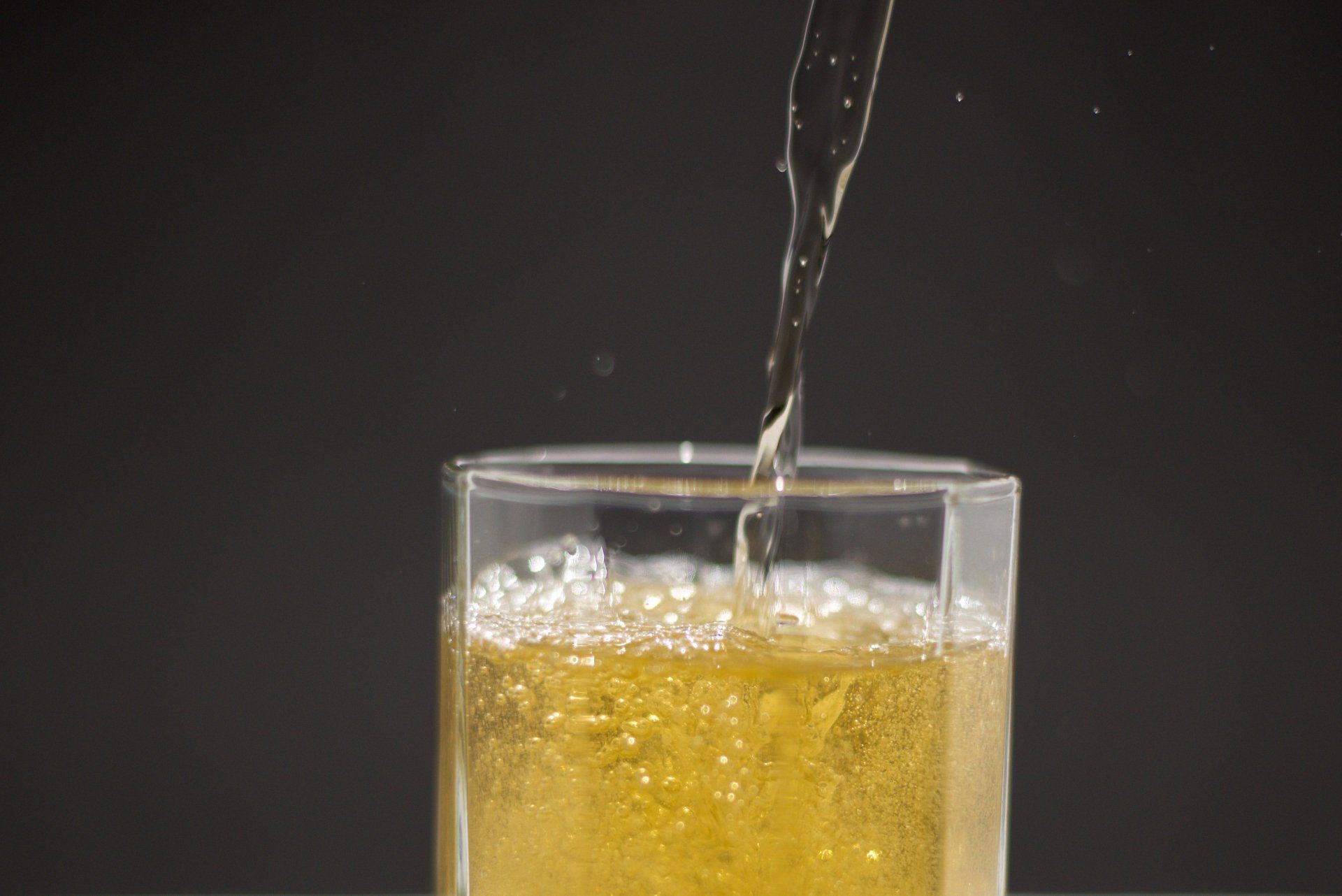 A glass of beer is being poured into a glass.
