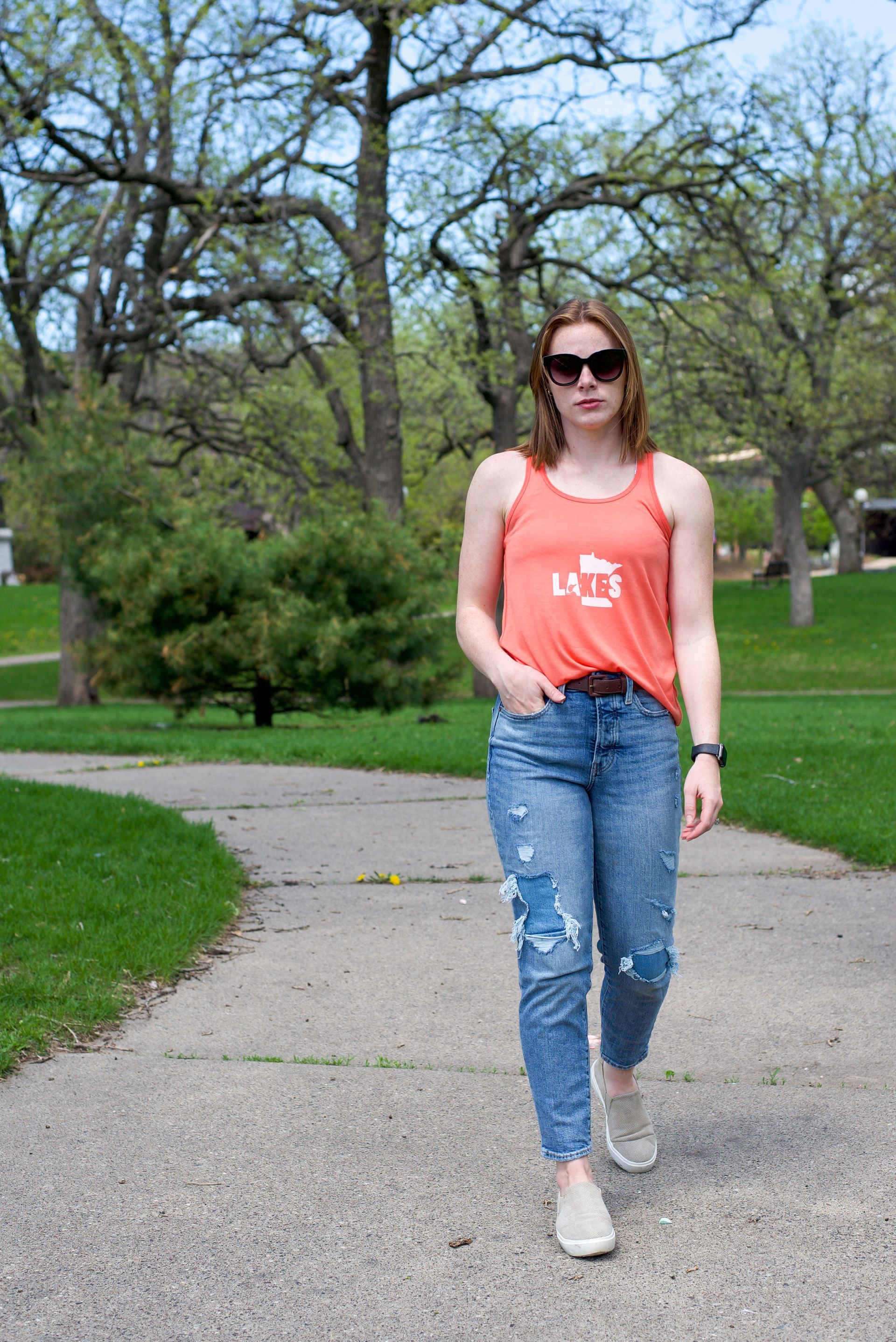 A woman wearing a tank top that says ucsd on it