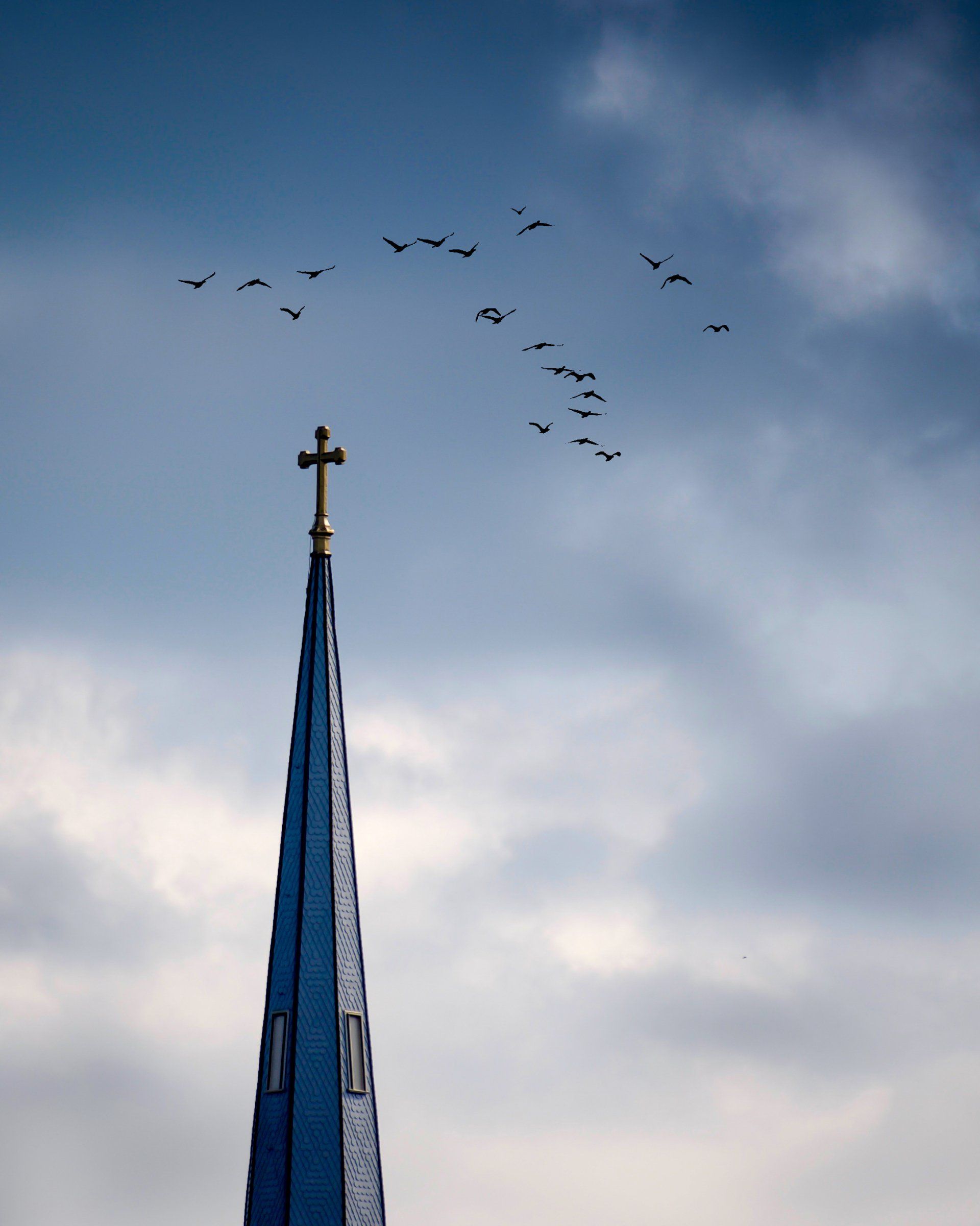 A church steeple with a cross on top of it