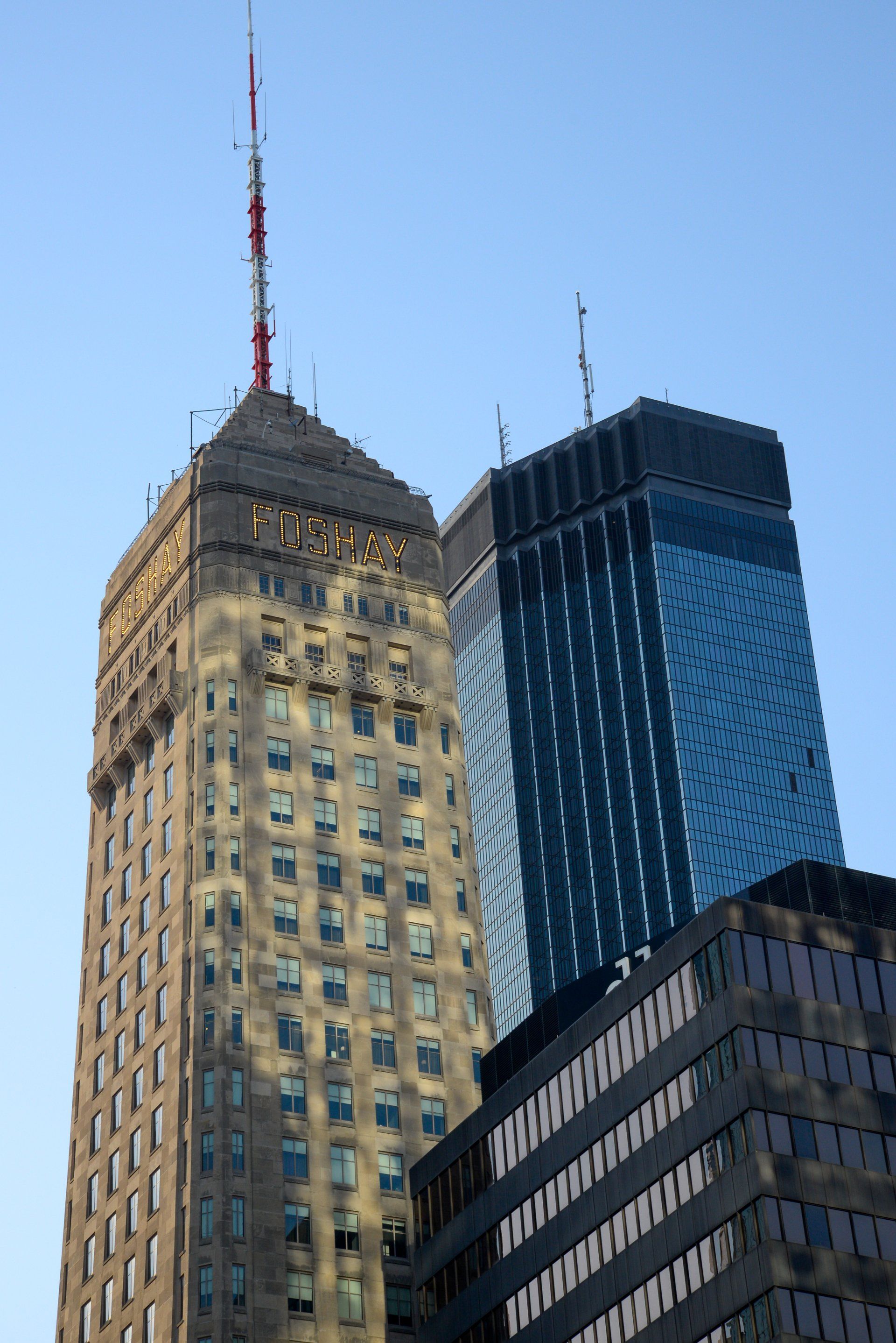 A very tall building with a very tall antenna on top of it