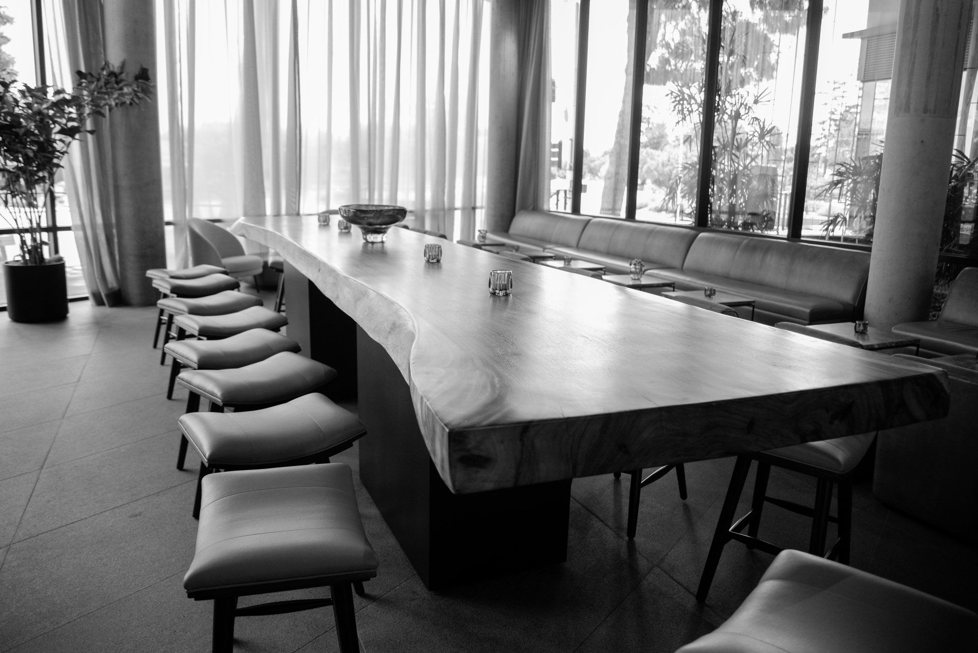 A black and white photo of a long wooden table