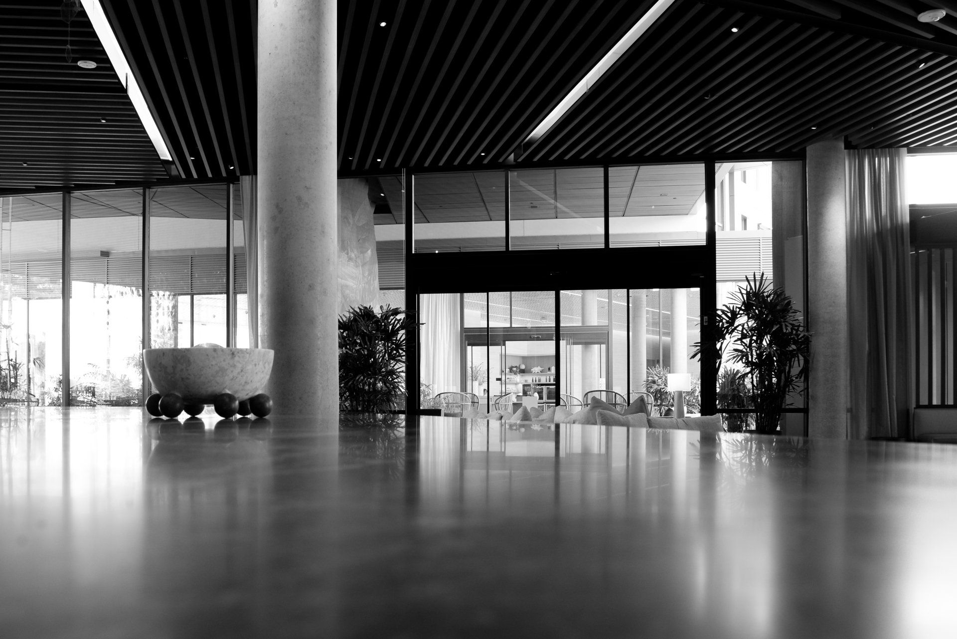 A black and white photo of an empty lobby in a building.