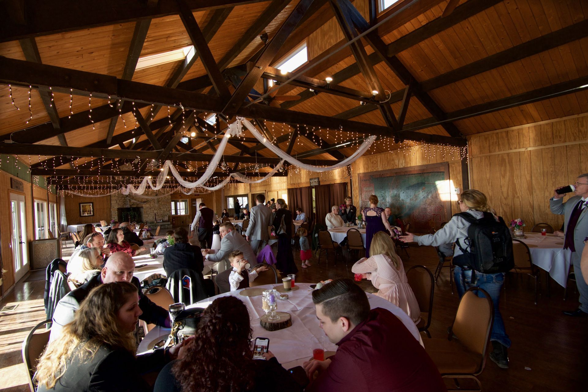 A group of people are sitting at tables in a large room