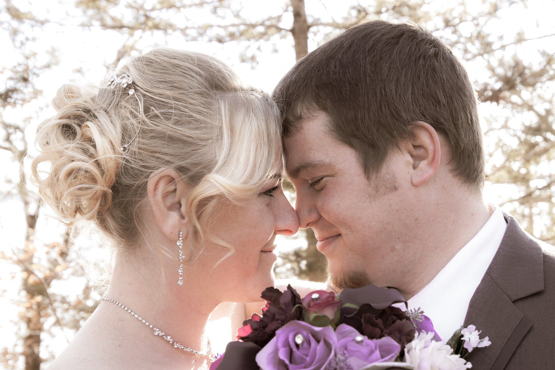 A bride and groom are looking into each other 's eyes