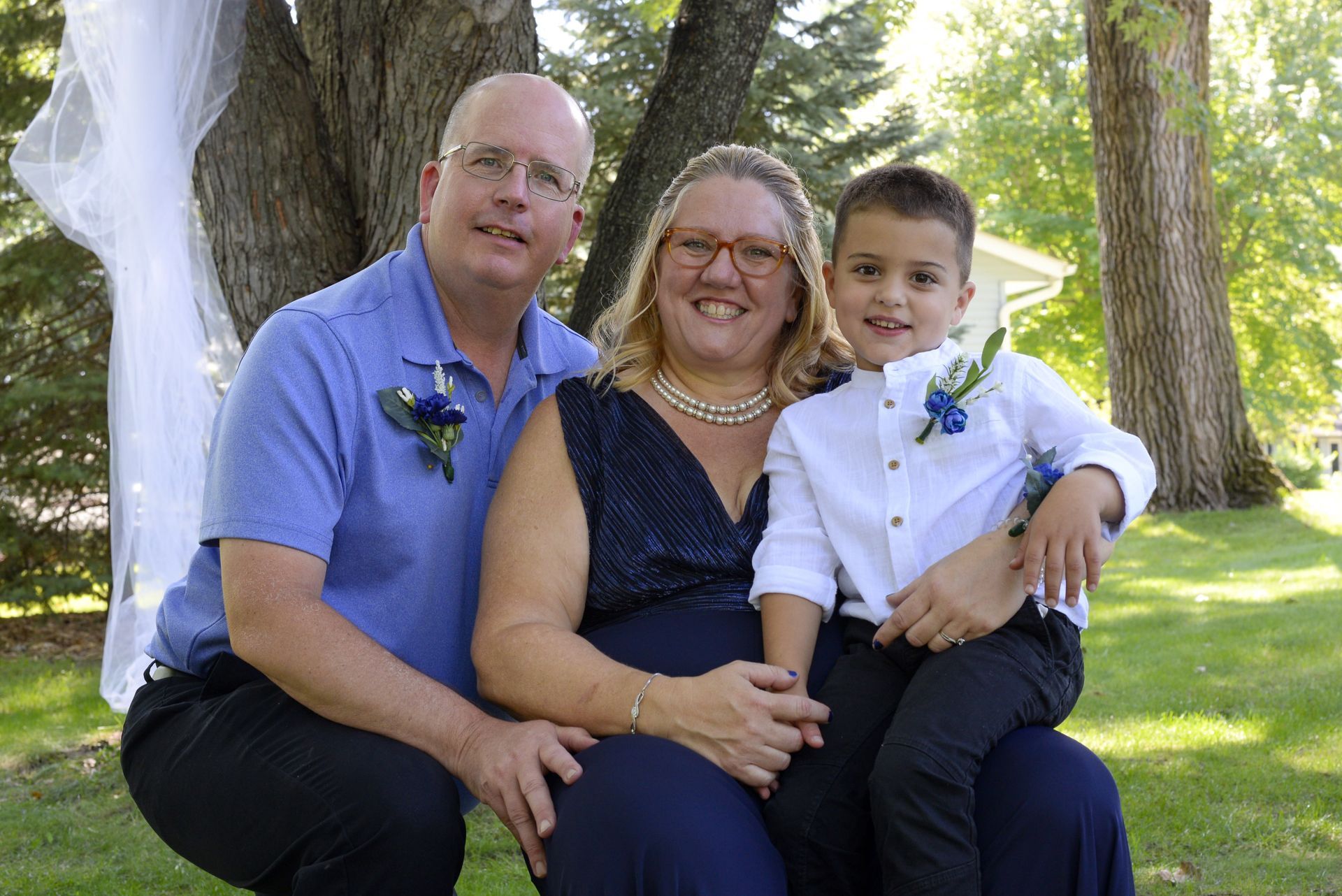 A man a woman and a child pose for a picture