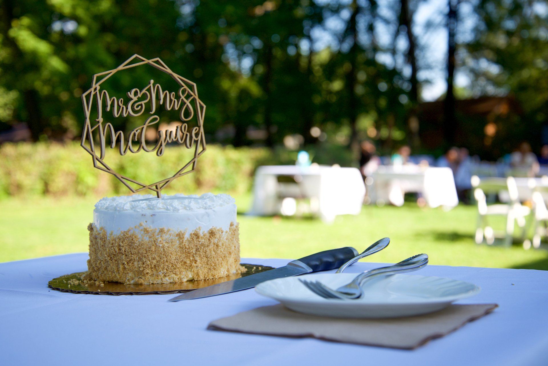 A cake with a topper that says mr. and mrs. on it