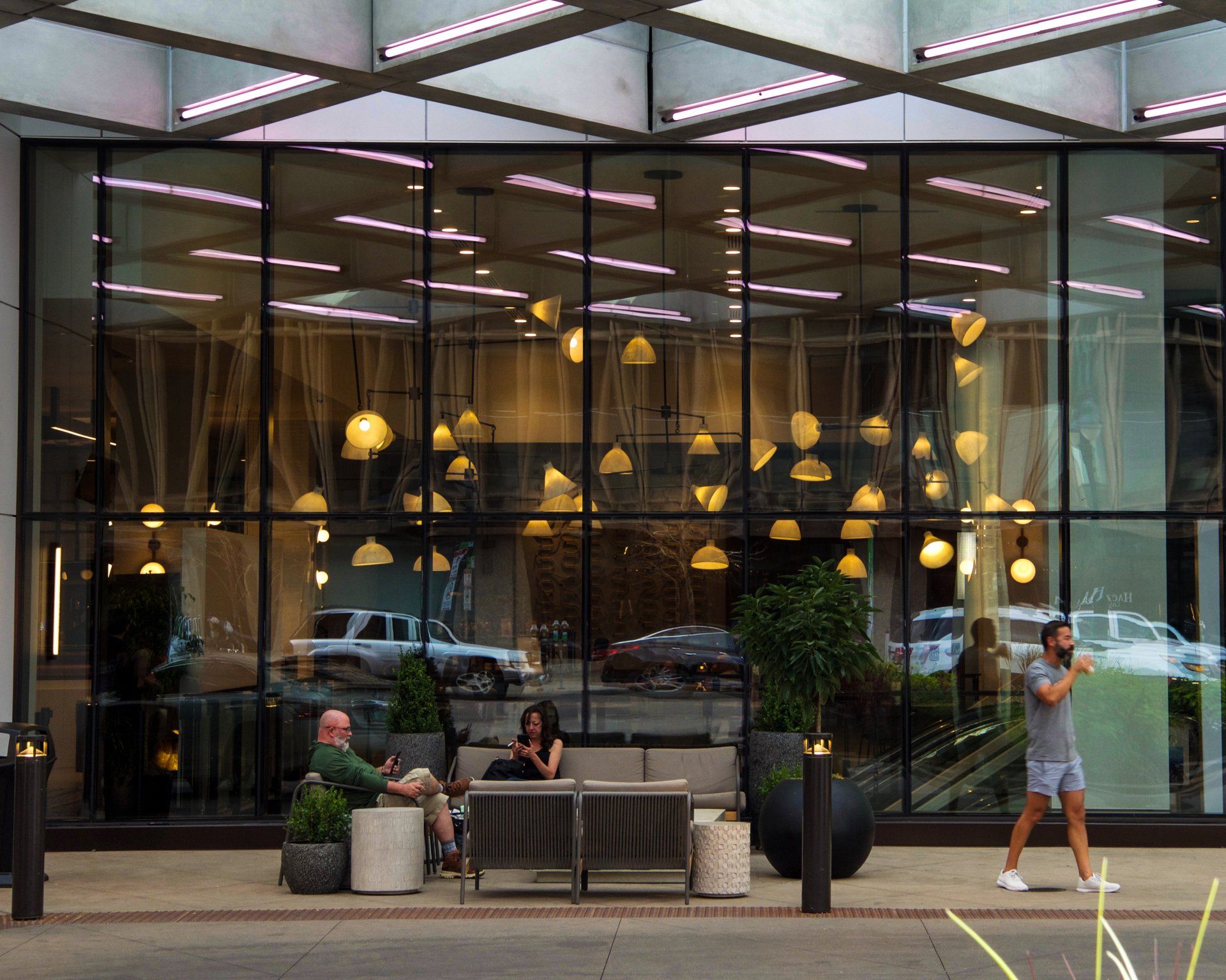 A man and woman sit on a couch outside of a building