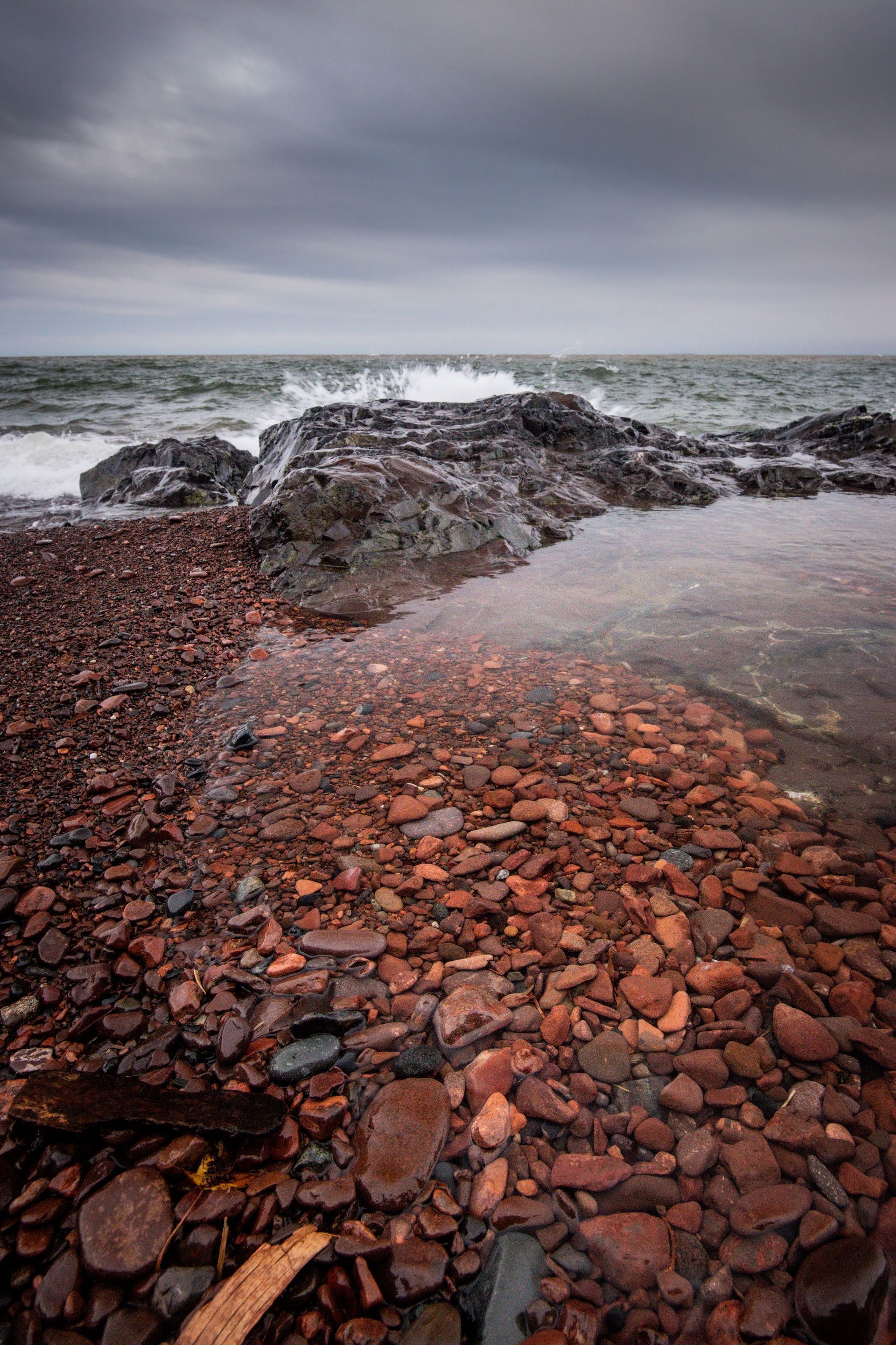 A rocky beach with waves crashing on the rocks