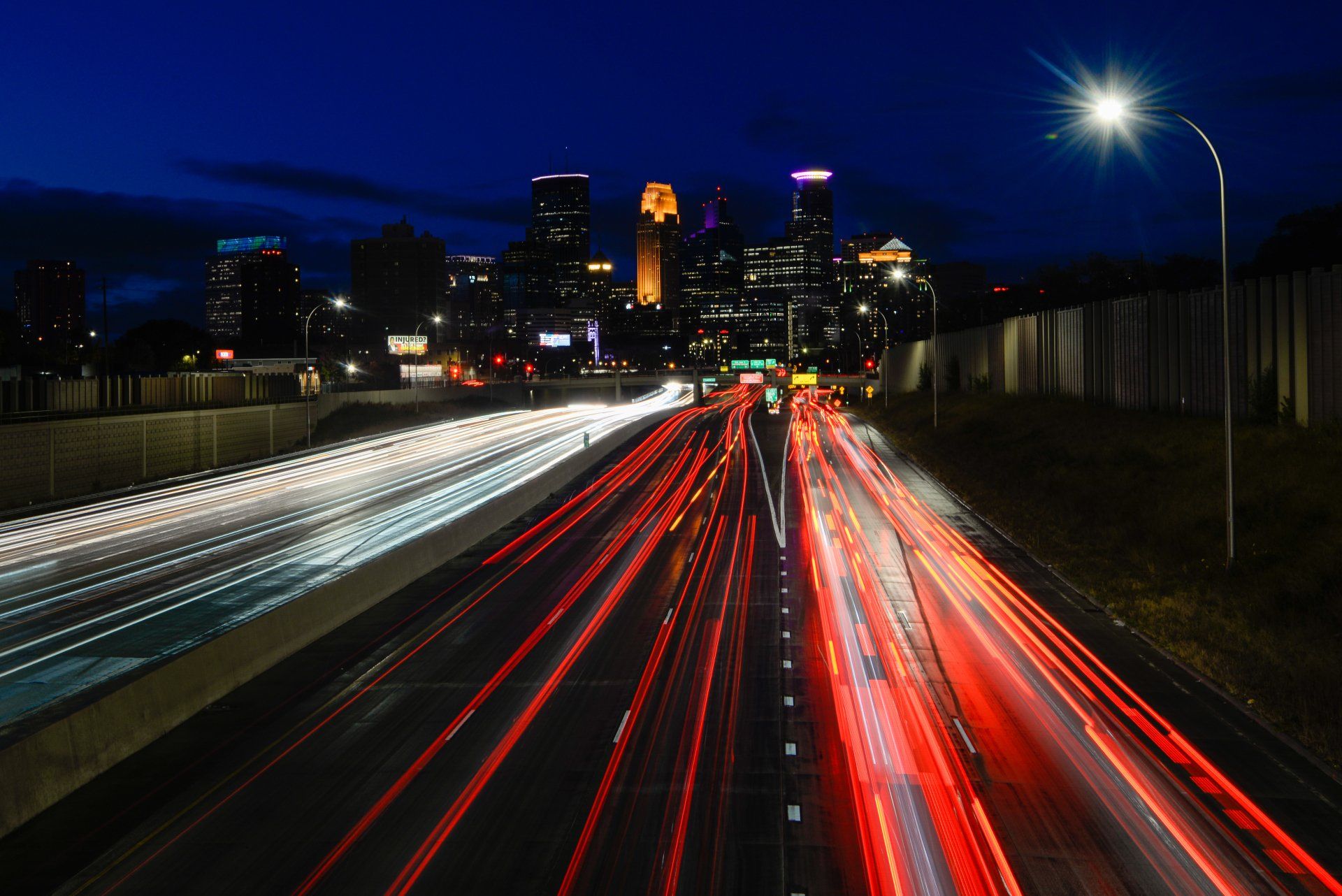A highway at night with a city in the background