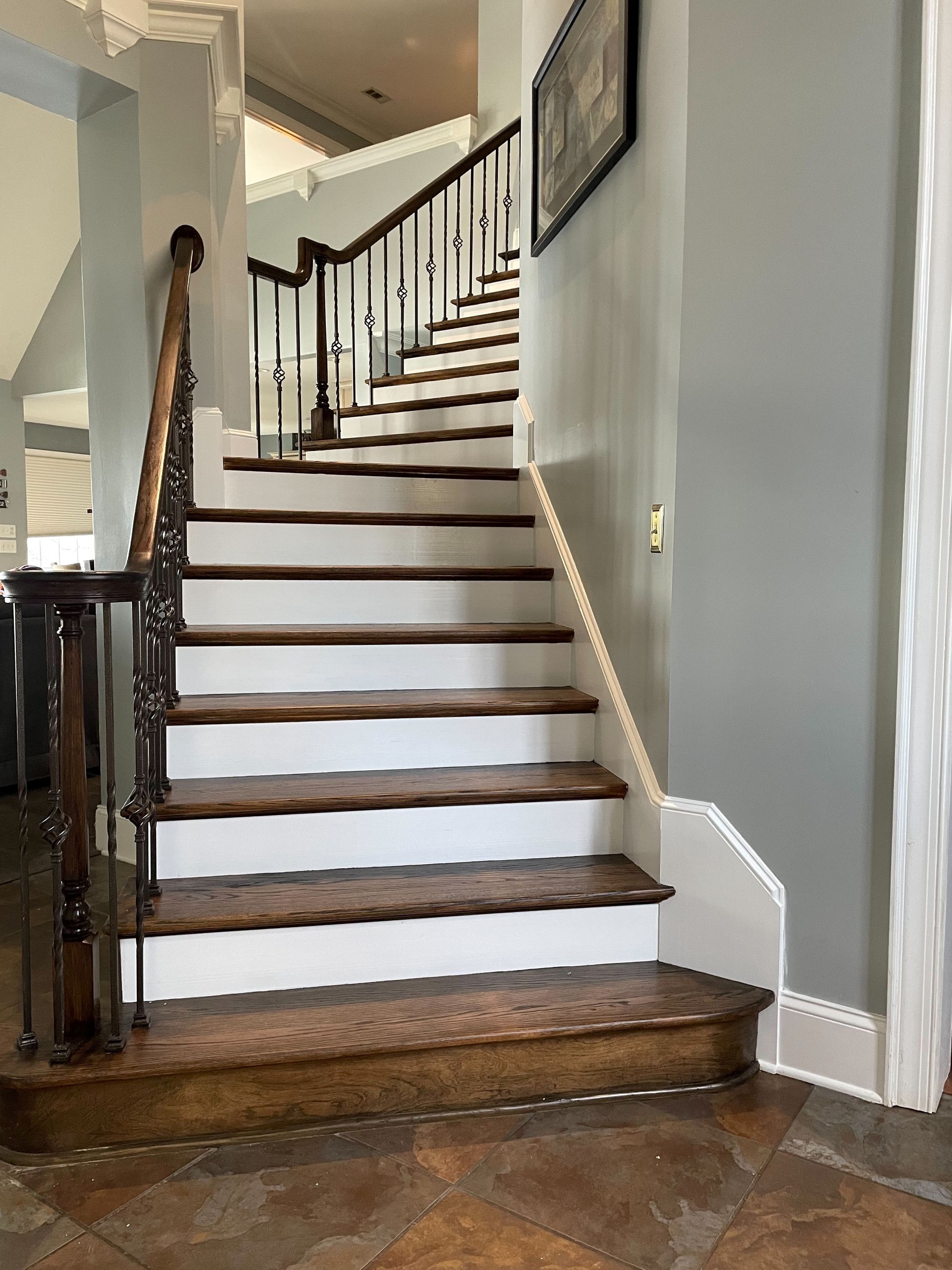 A staircase with wooden steps and white steps in a house.