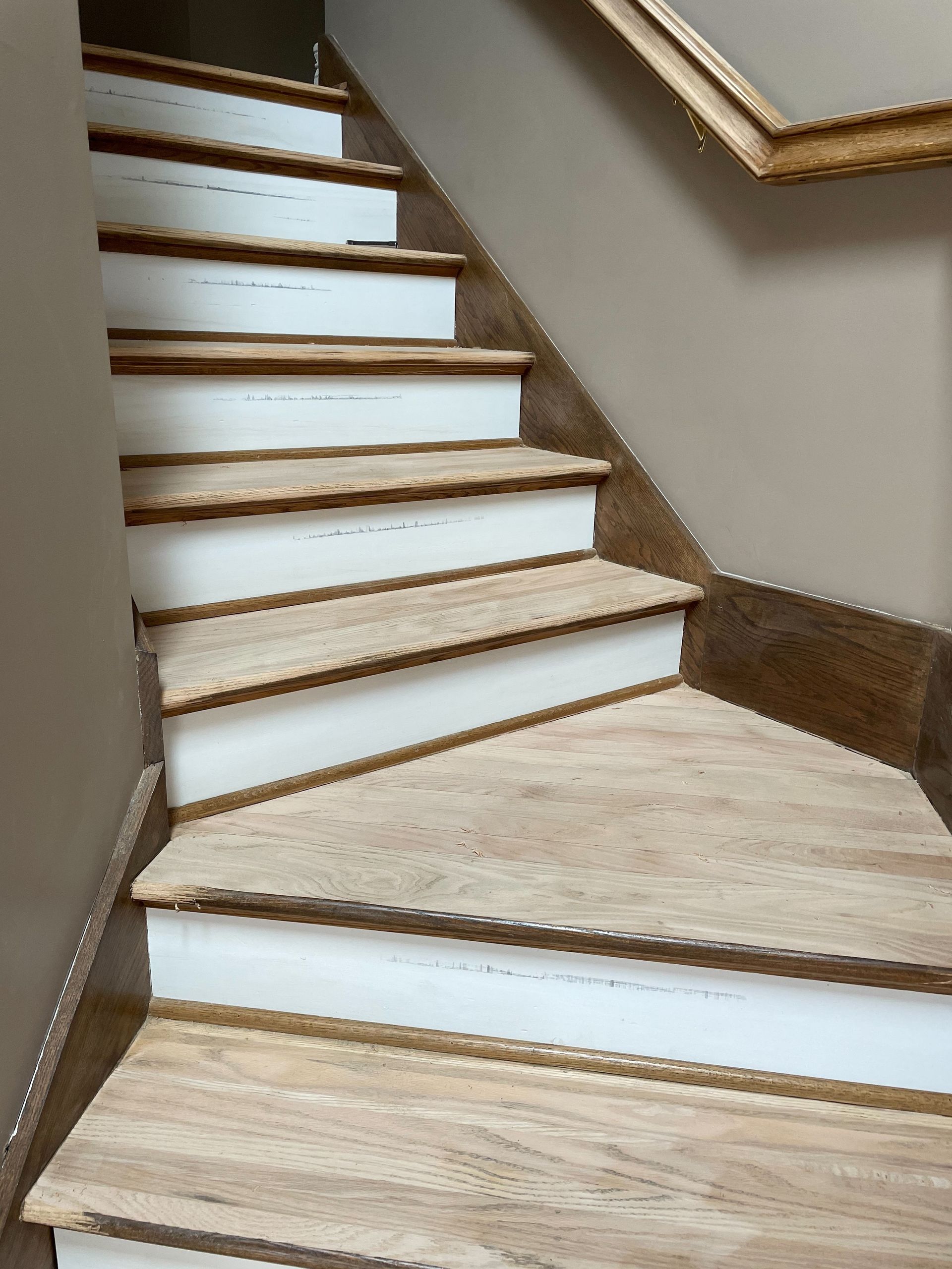A wooden staircase with white steps in a house
