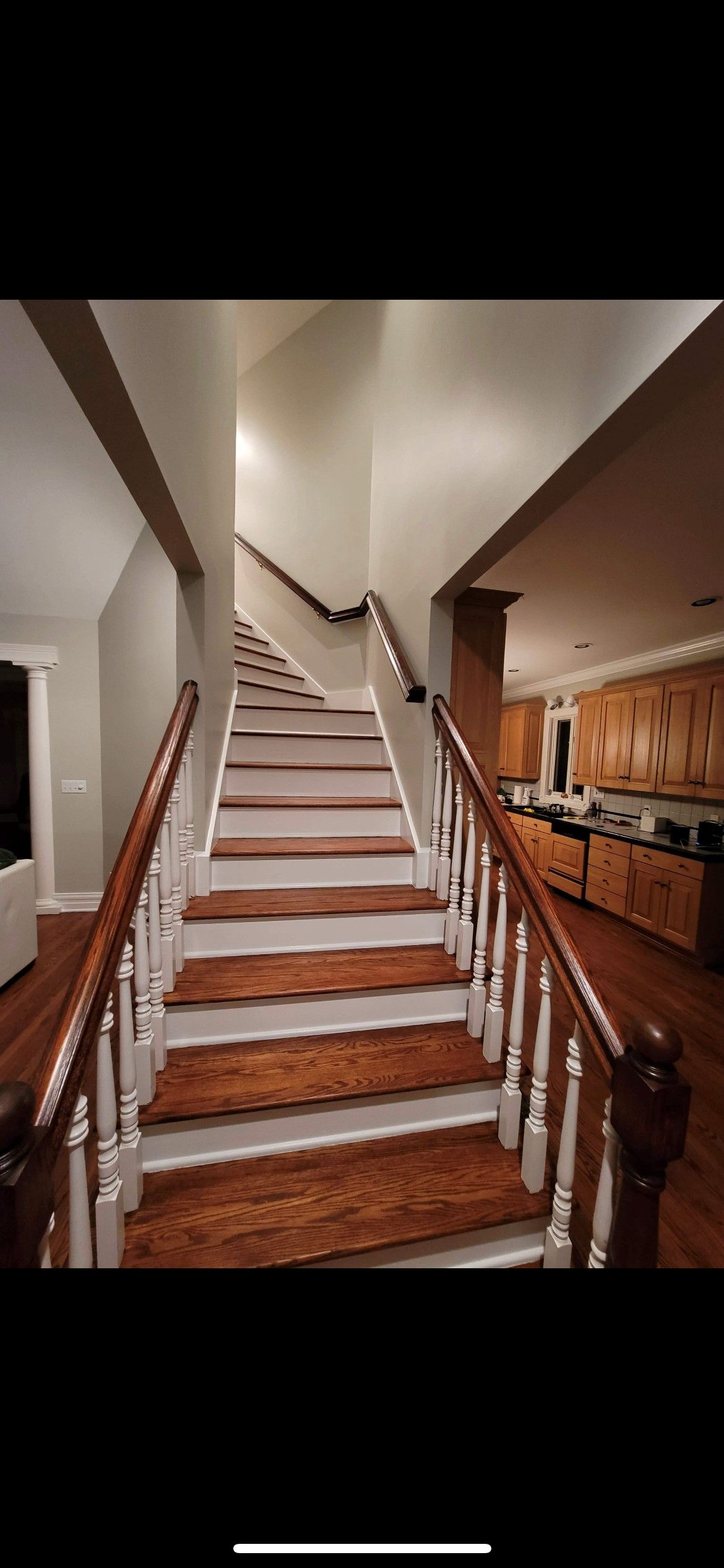 A set of stairs leading up to a kitchen in a house.
