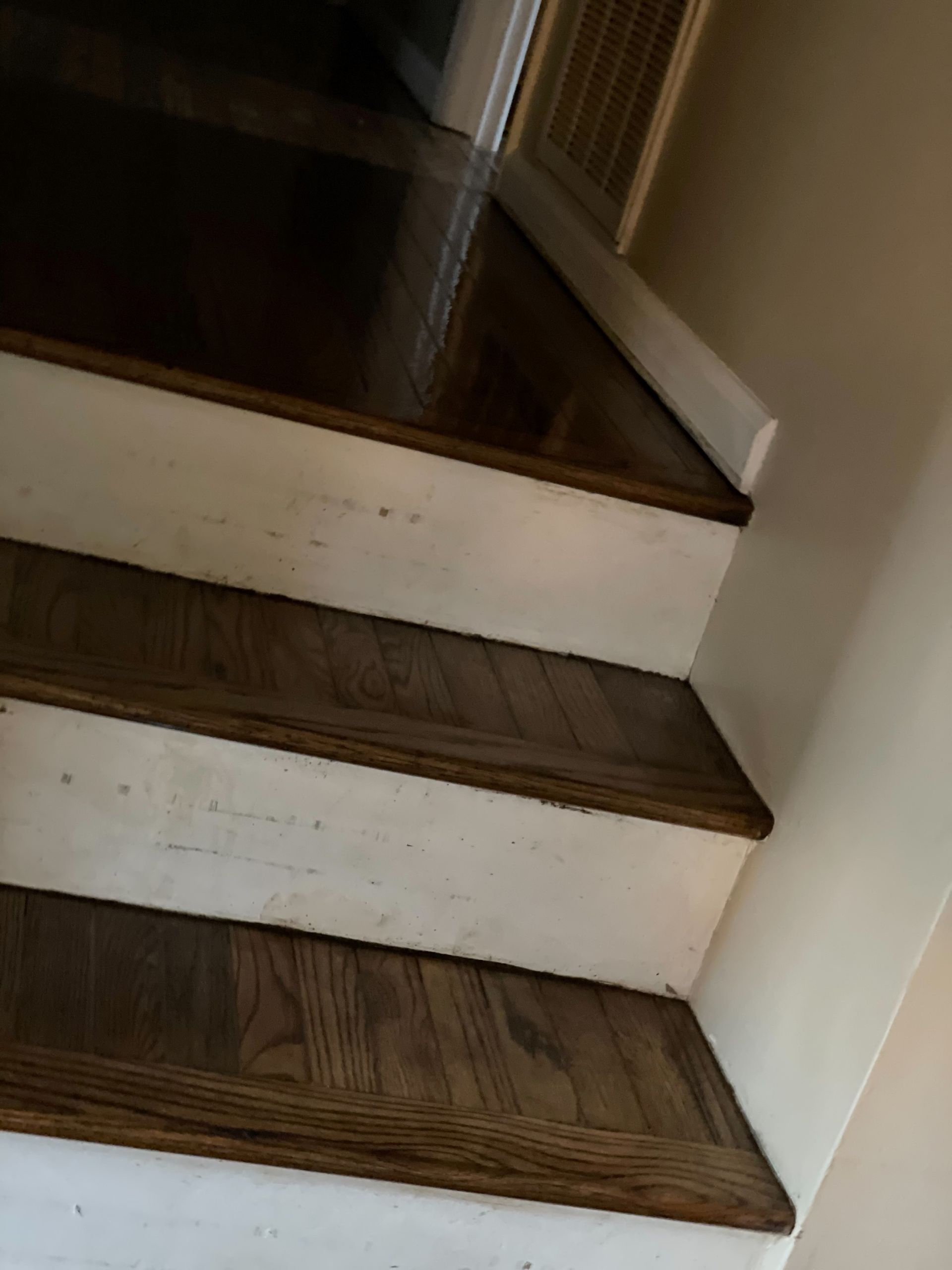 A set of stairs with wooden steps and white risers