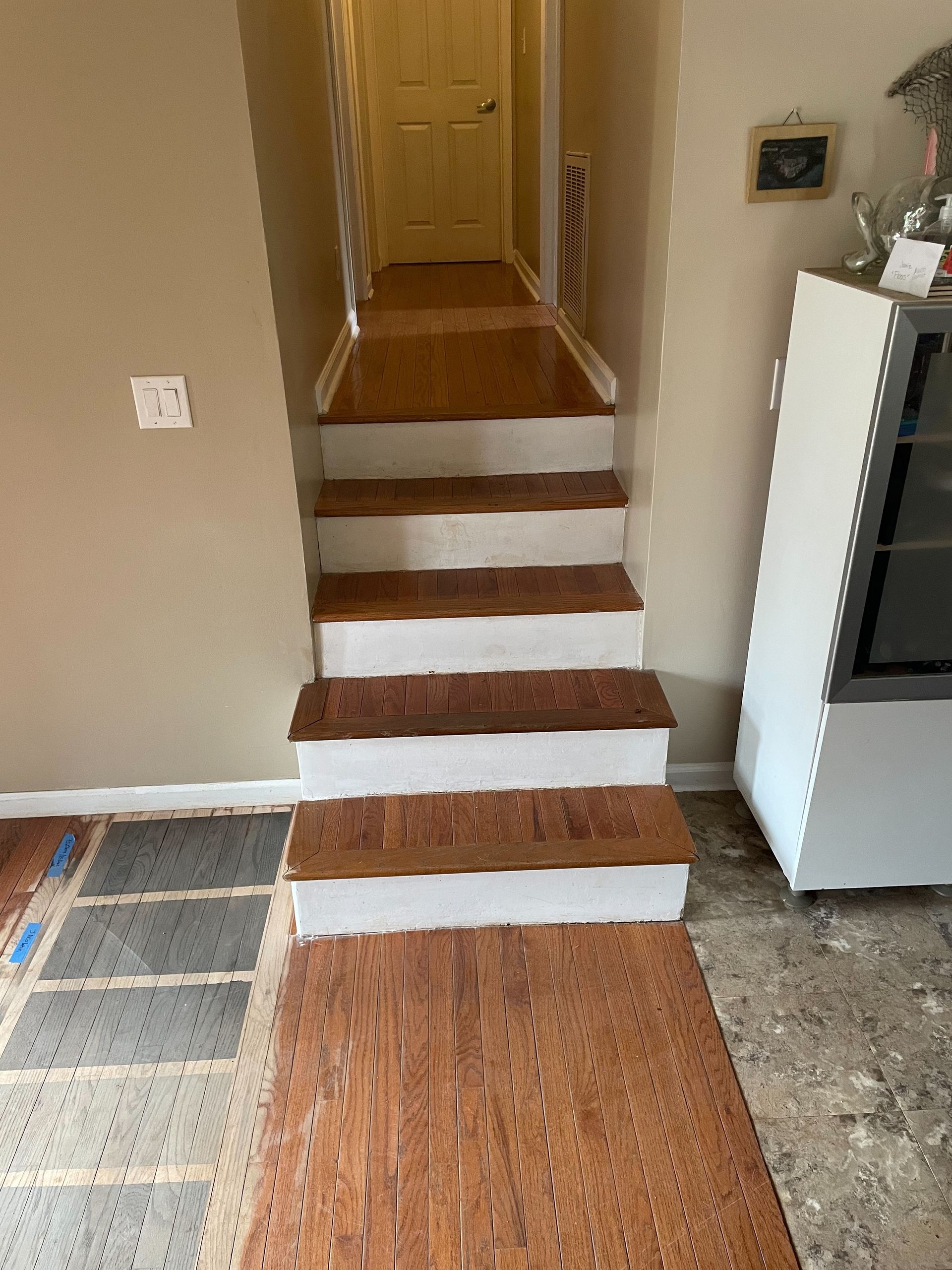 A set of stairs leading up to a hallway in a house.