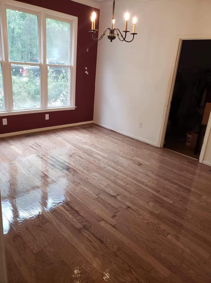 A living room with hardwood floors and a chandelier.