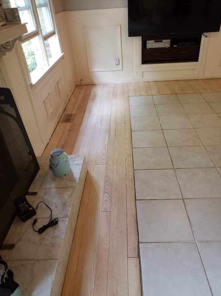 A living room with wooden floors and tile floors