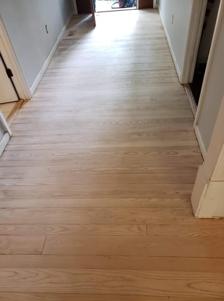 A hallway with a wooden floor in a house.