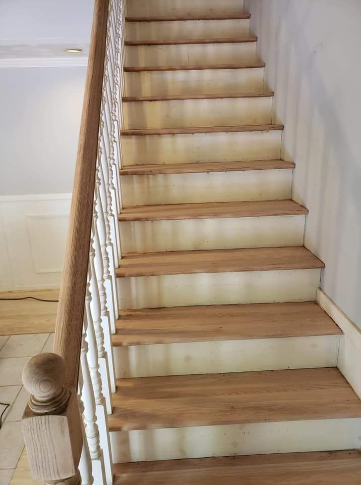A staircase with wooden steps and a white railing