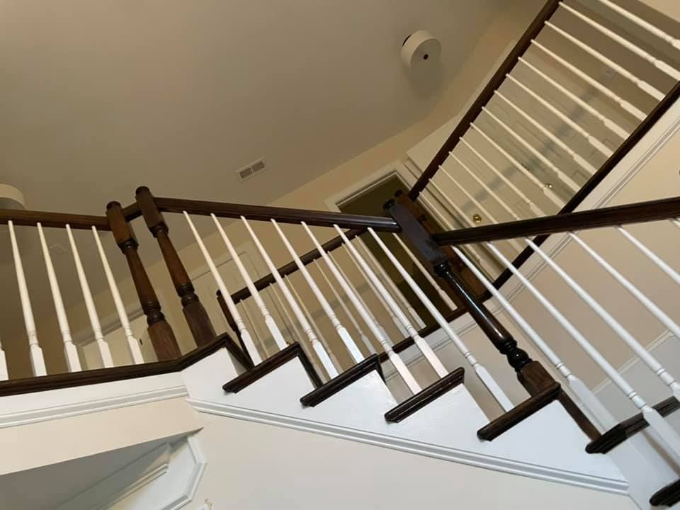 A staircase with a wooden railing and white steps